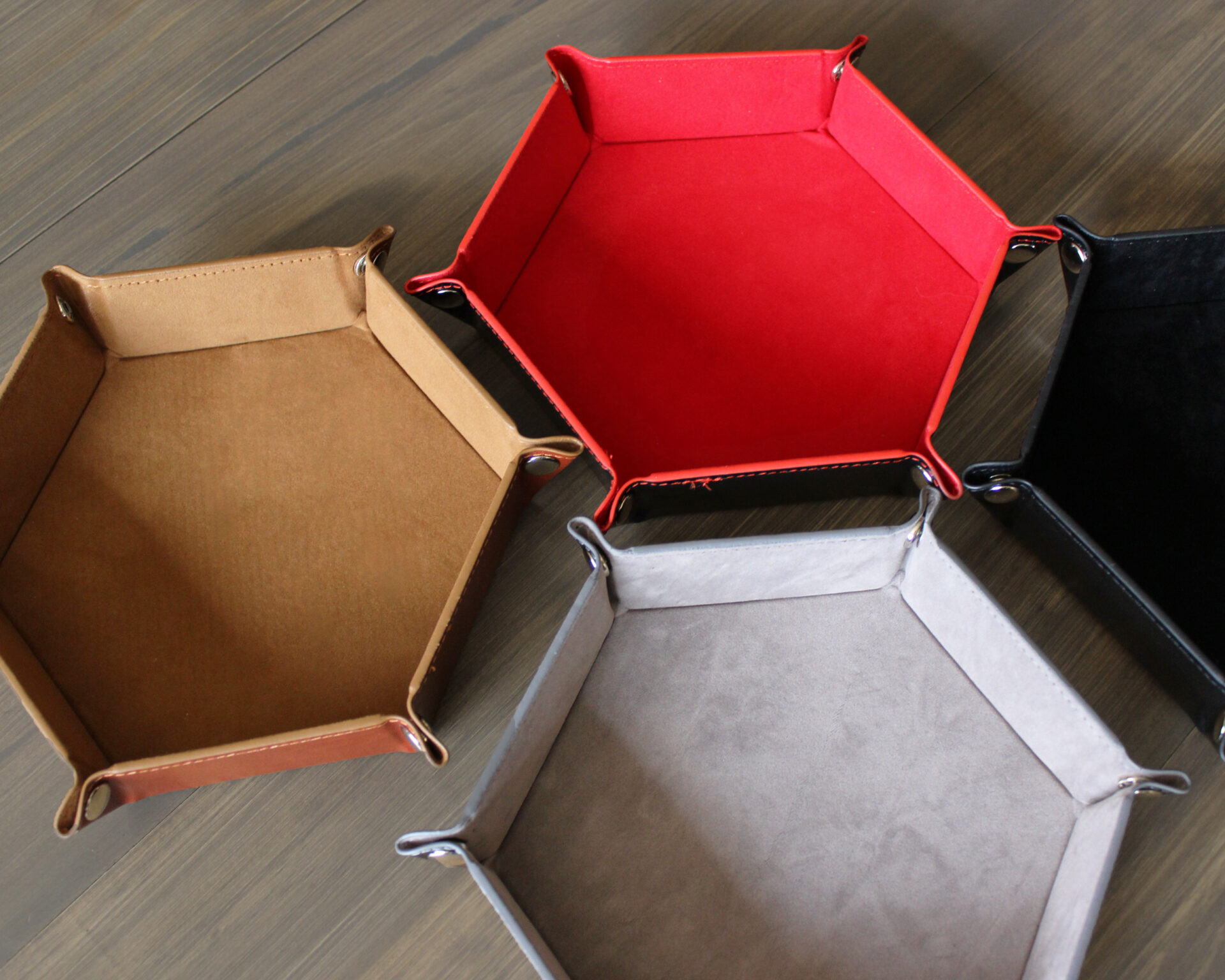 Hexagon snapping dice trays featuring brown, red, grey, and black